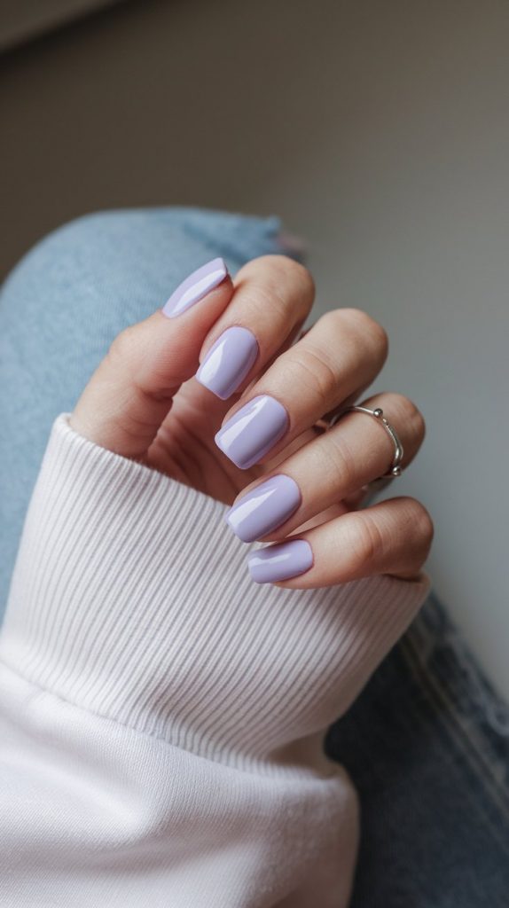 Short square nails in a cool frosted-lilac crème.