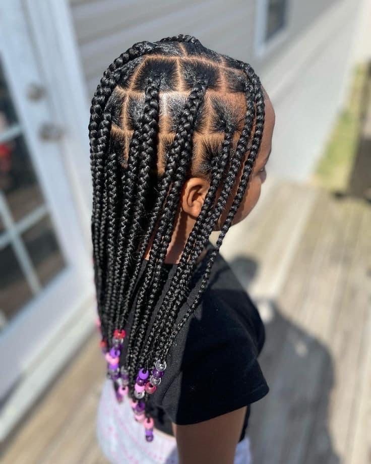 Jumbo box braids with beads on a young girl