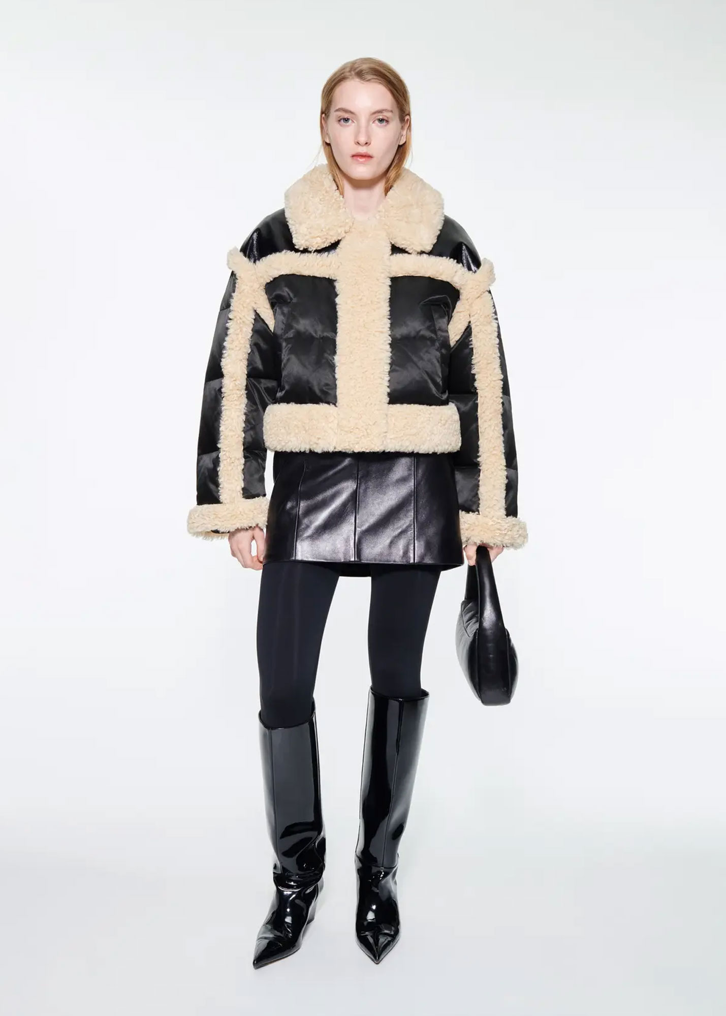 Black satin quilted jacket with cream shearling trim, black leather mini skirt, leggings and knee-high boots