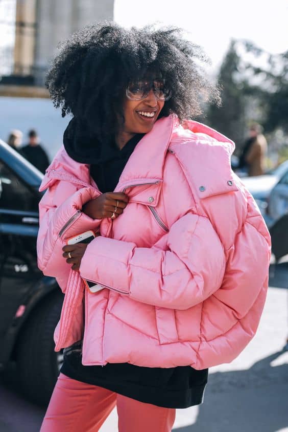 Woman in an oversized pink puffer jacket, winter street style