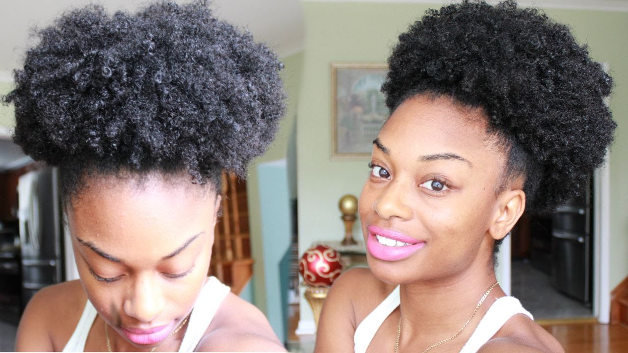 A high, full afro puff on natural textured hair