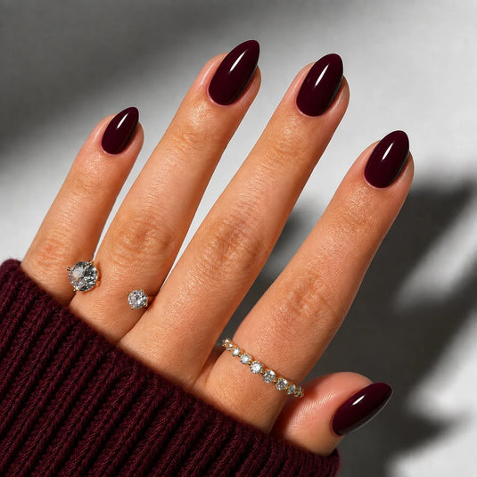 Glossy deep burgundy almond-shaped nails