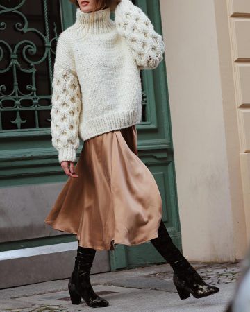Chunky knit sweater paired with a satin midi skirt