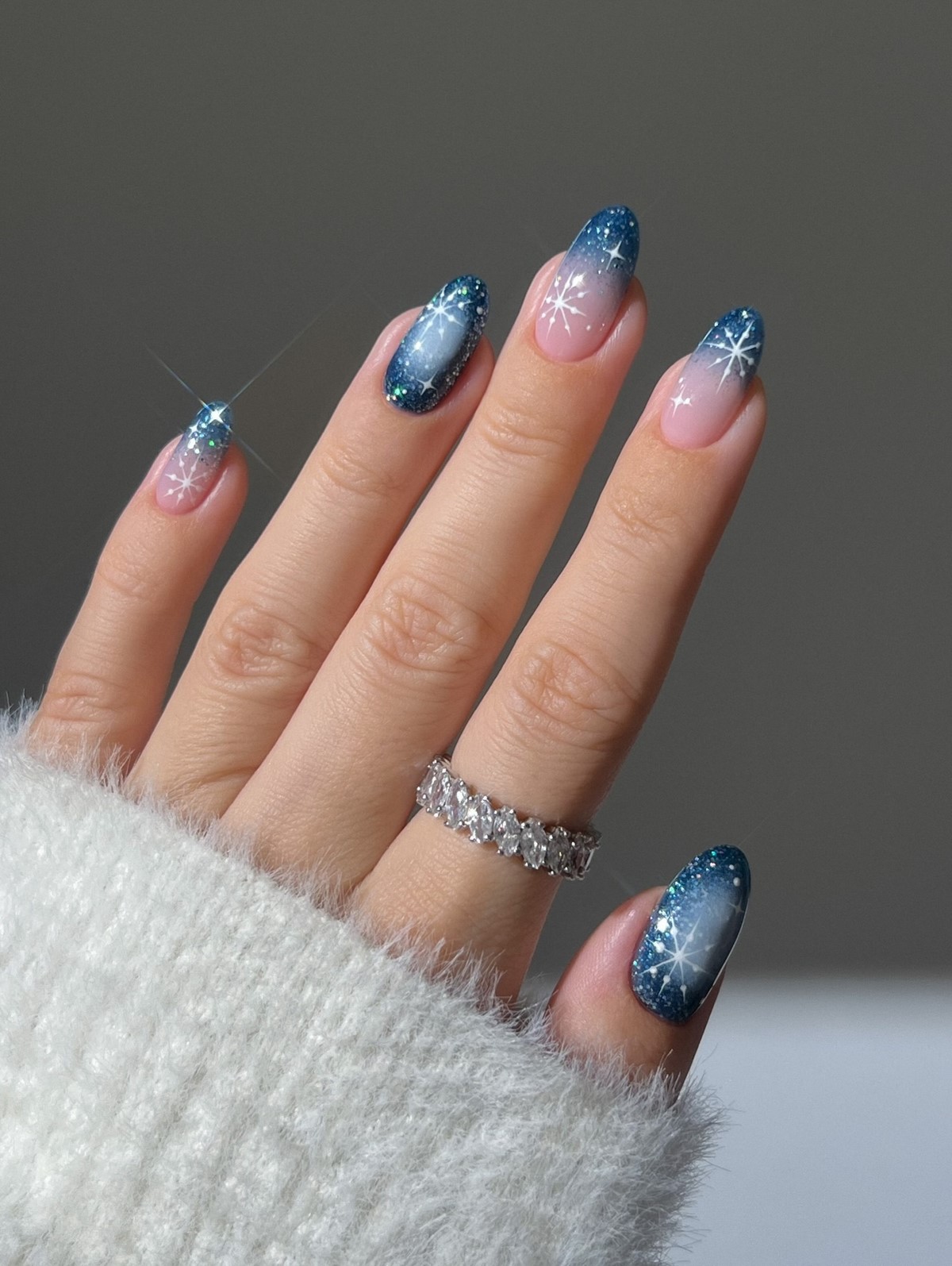 Long almond winter nails with midnight blue aura gradient