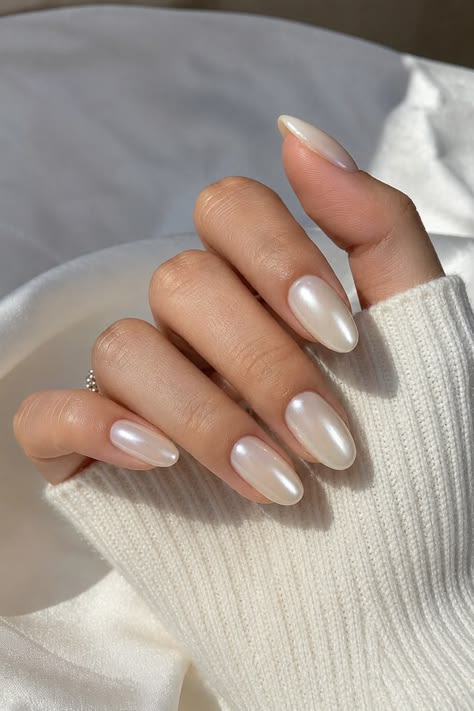 Close-up of nails with a glossy white pearl chrome finish