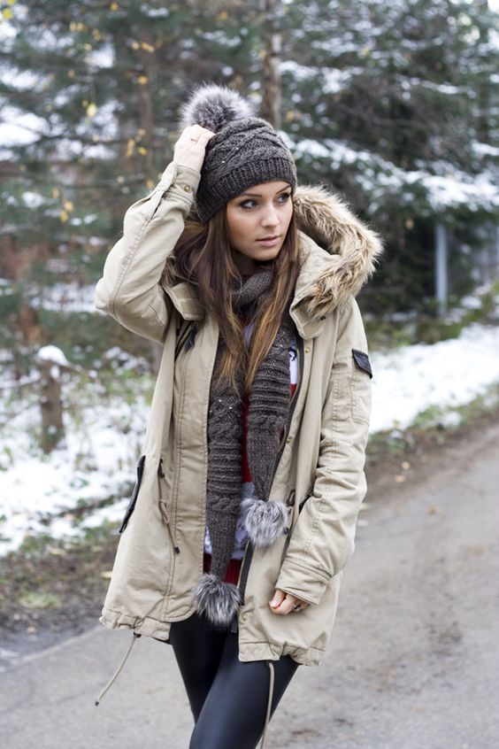 Woman in a parka with fur-trimmed hood worn over thermal leggings in winter