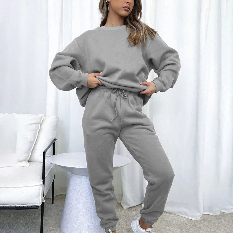 Woman wearing a matching grey long-sleeve sweatshirt and jogger set