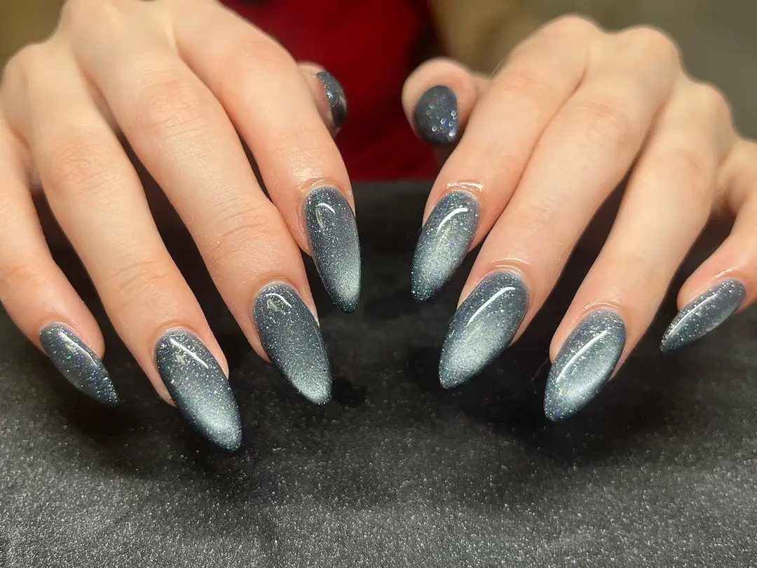 Long almond charcoal cat-eye nails with silver glitter