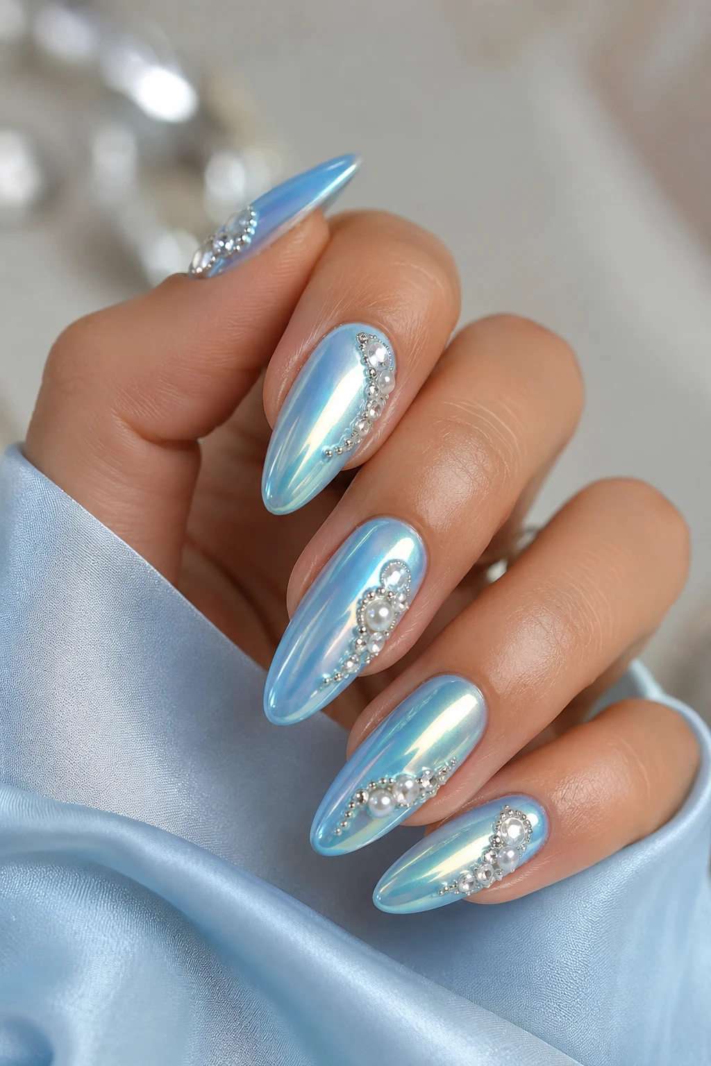 Almond nails with pale blue iridescent chrome finish