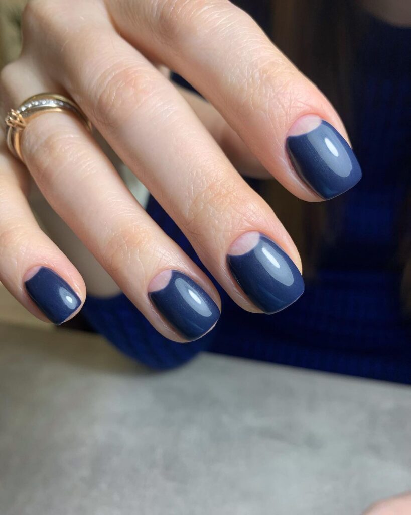 Short squoval navy nails with bare half-moon cuticles
