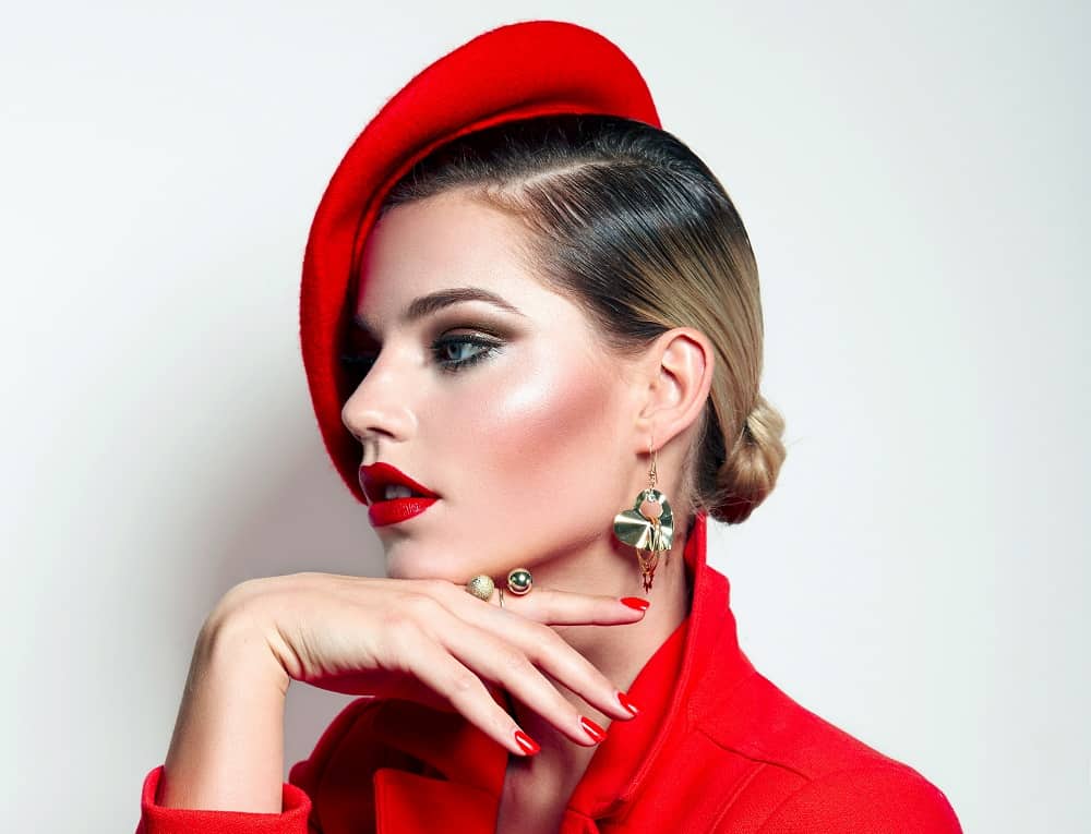 Woman in a red beret with a sleek blonde low bun