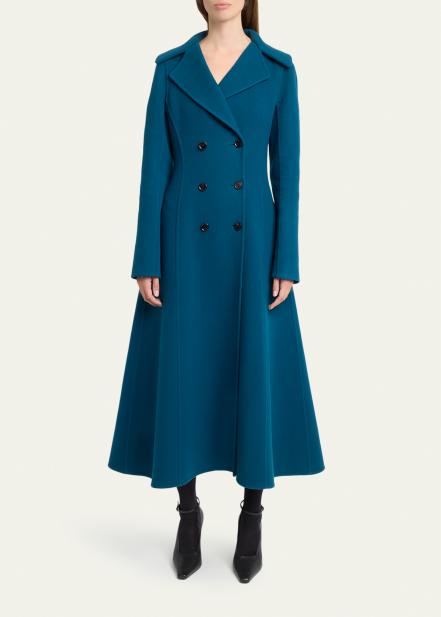 Woman wearing a teal coat with black tailored trousers