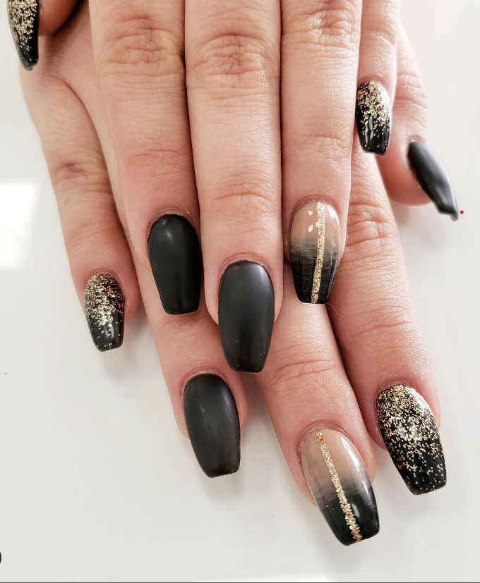 Matte black coffin nails mixed with gold glitter fade and ombre accent nails