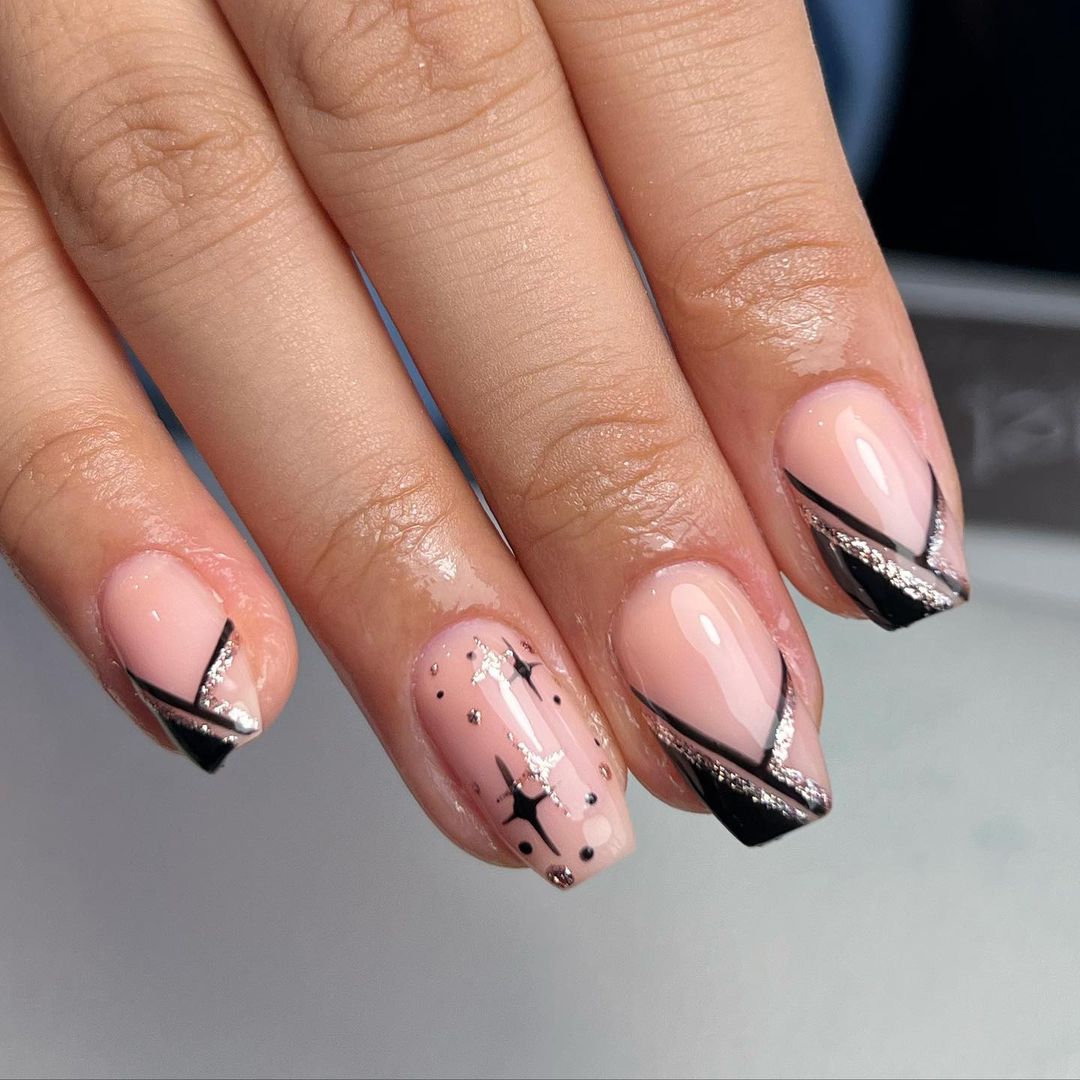 Black french tip nails with gold celestial star and moon designs