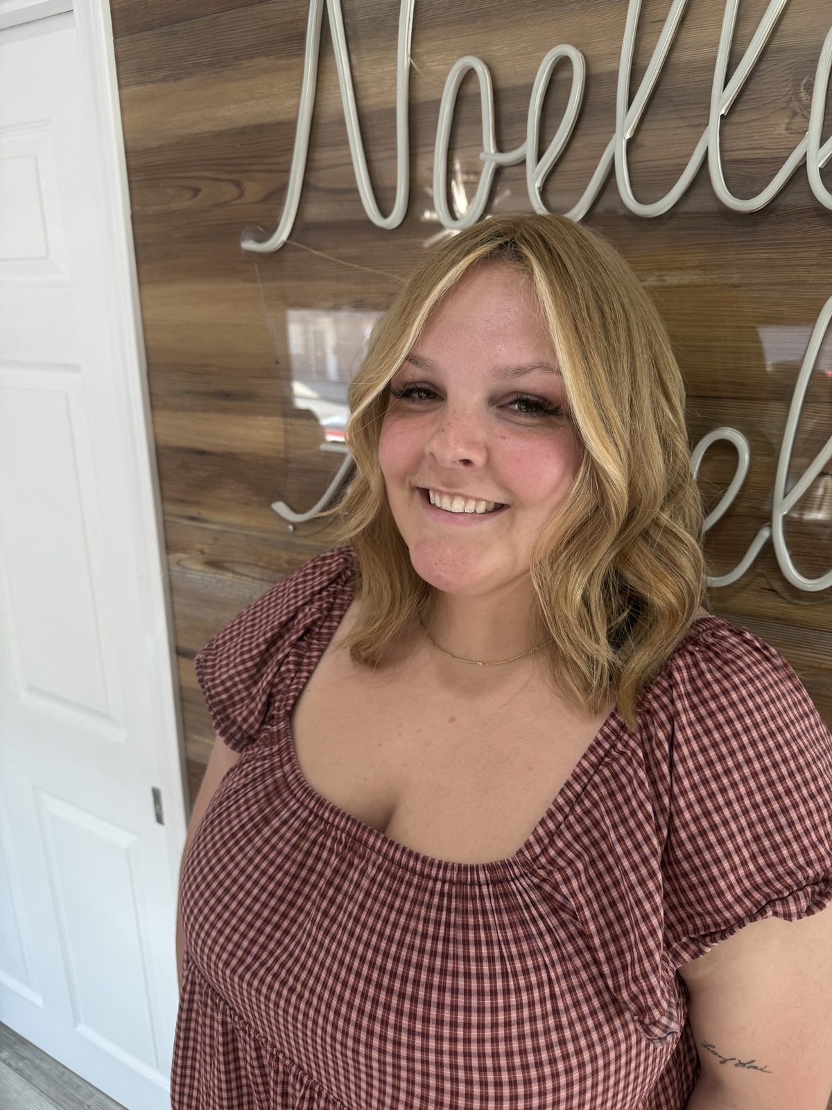 Blonde bob with bright face-framing highlights, colored and cut at Noelle Salon