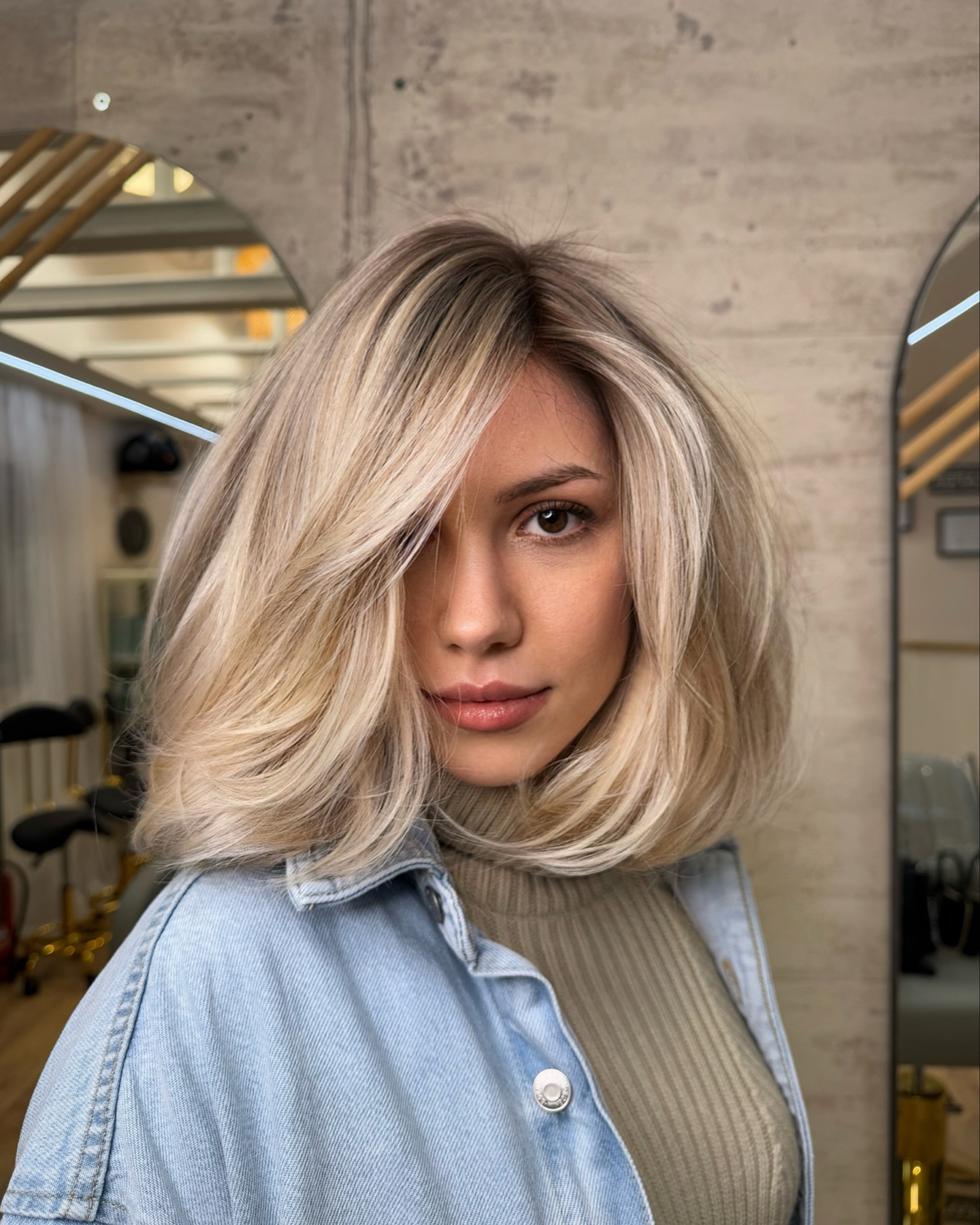 Blonde textured Italian bob with long face-framing layers and soft flip
