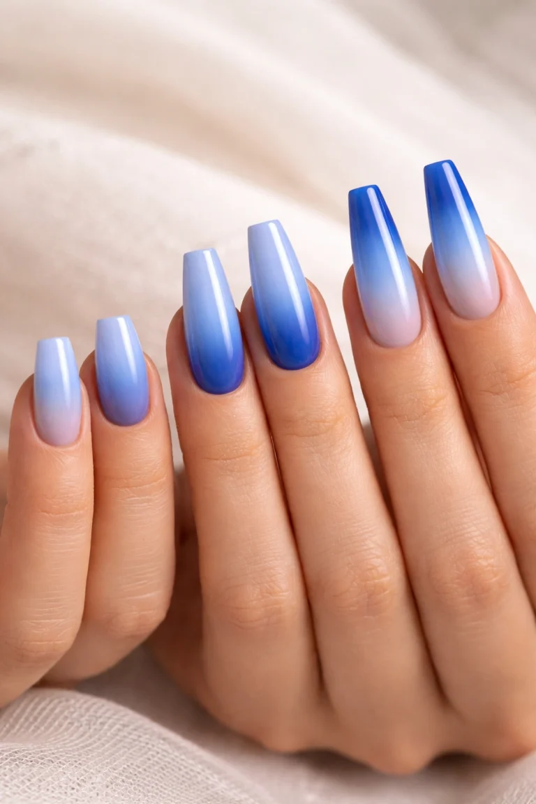 Oval nails with a blue to white gradient ombre
