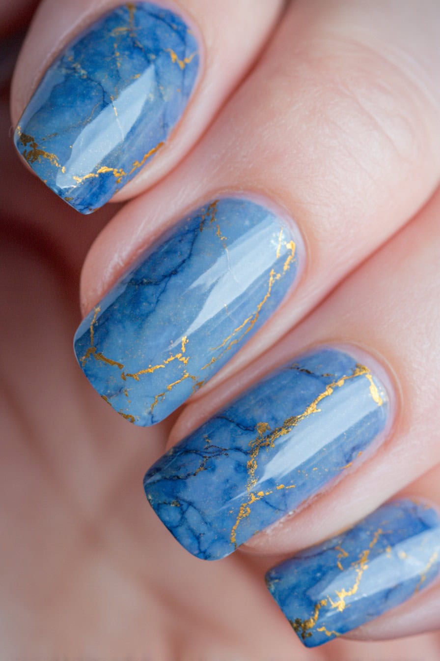 Icy blue marble nails with metallic foil veining