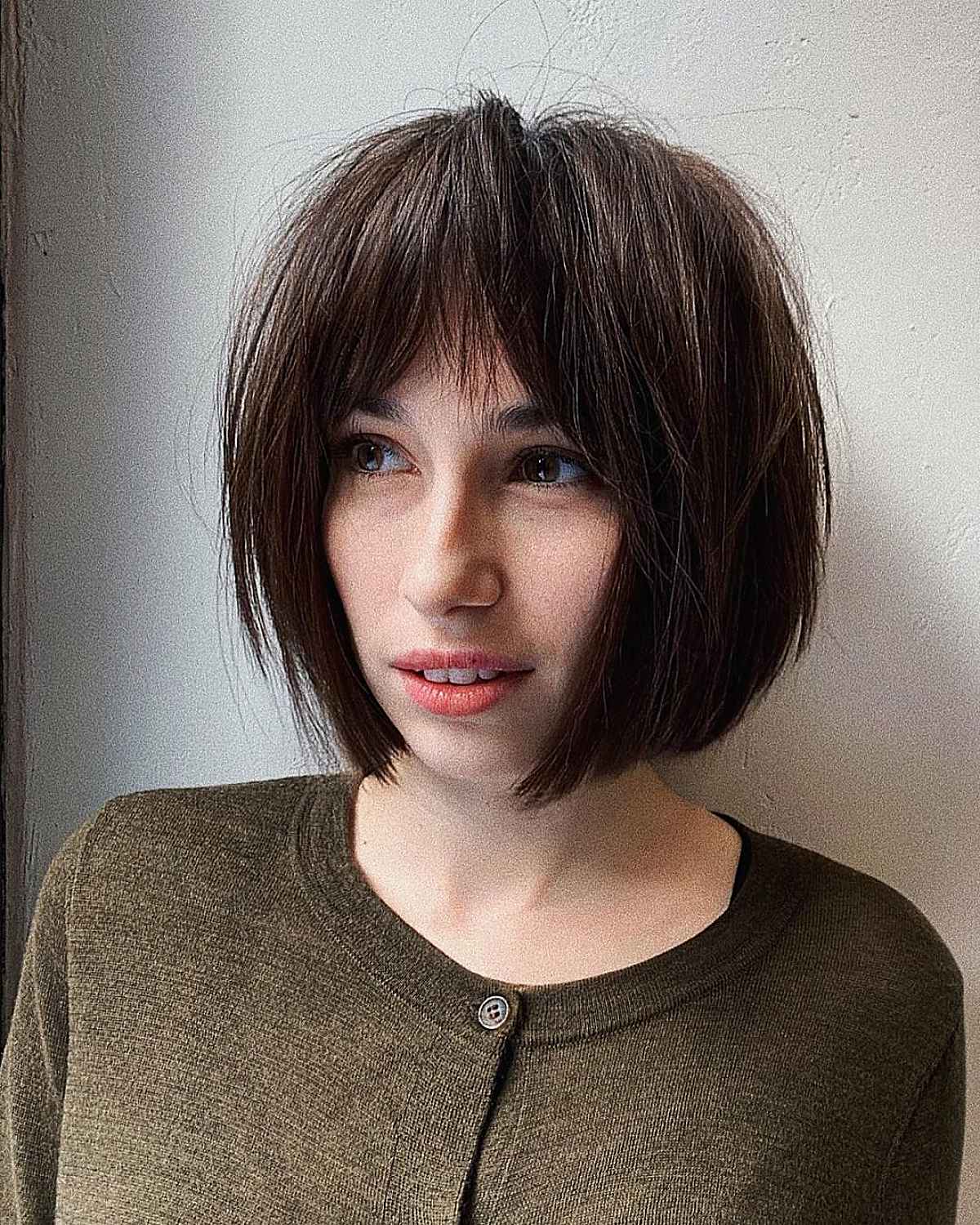 Bob haircut with layered curtain fringe parted in the middle