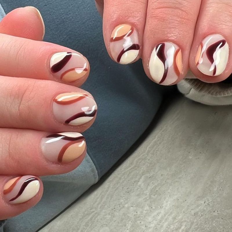 Short nails in cocoa brown with caramel swirl nail art
