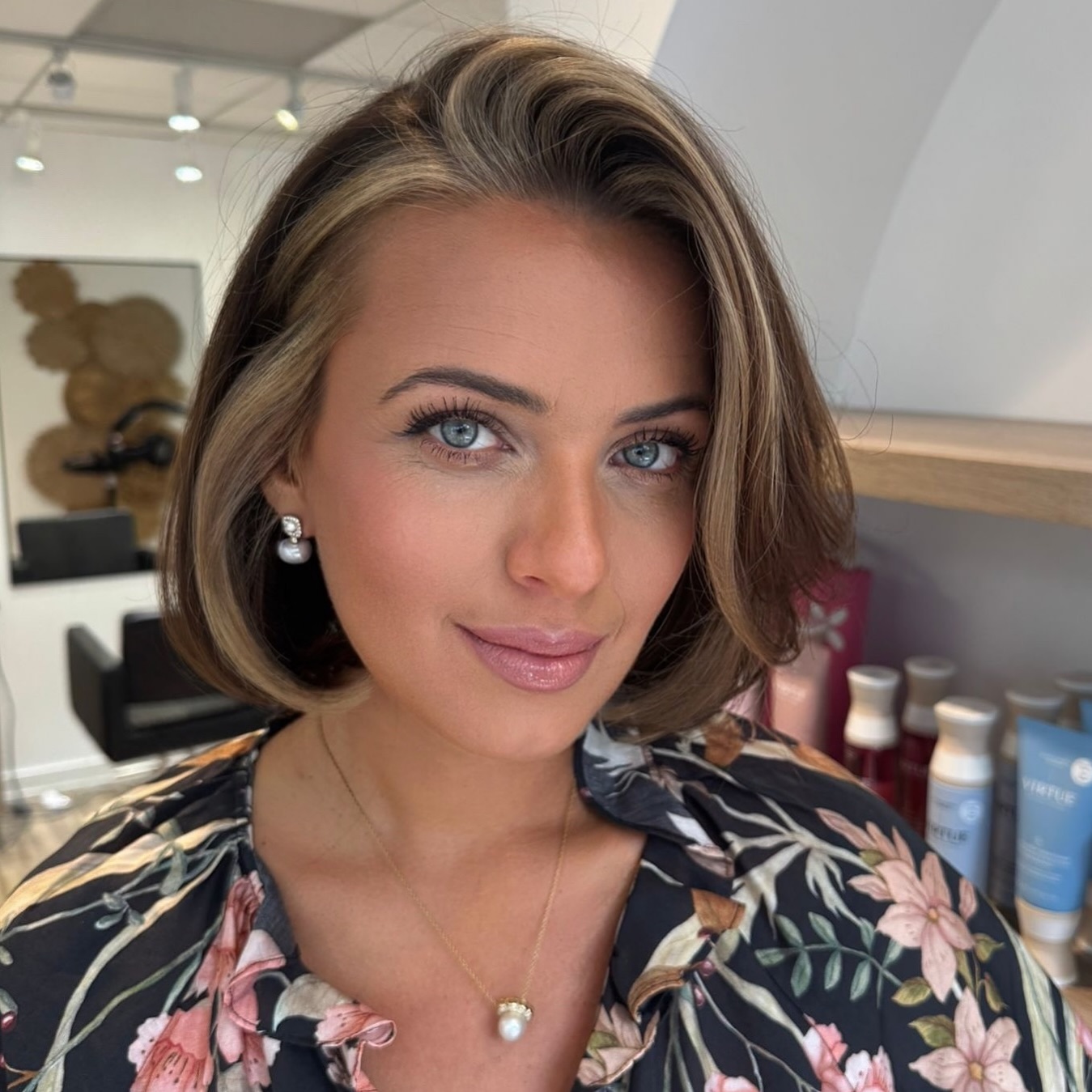 Brushed-back chin-length Italian bob with subtle peekaboo blonde front slice