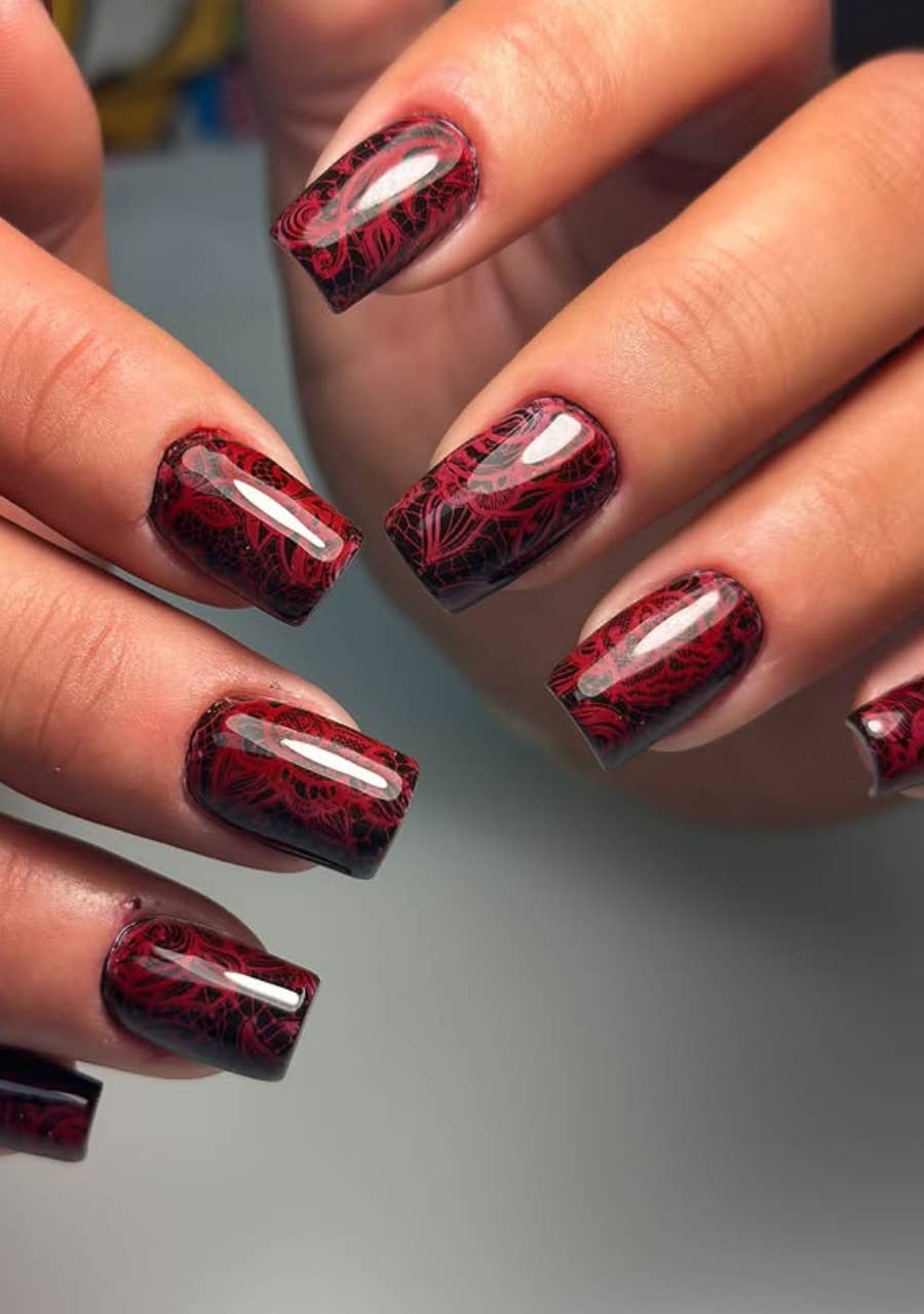 Deep cherry red nails with black lace-pattern stamping