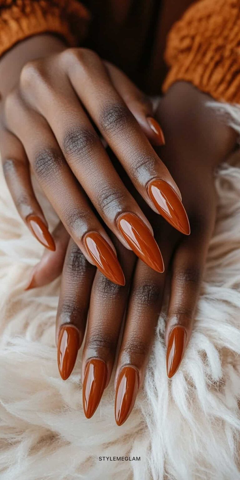 Short oval nails in burnt orange cinnamon polish