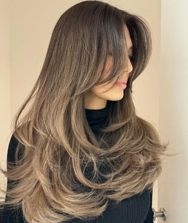 Long hair with bouncy blowout layers and curtain fringe