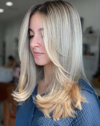 Warm honey blonde hair with a soft root shadow