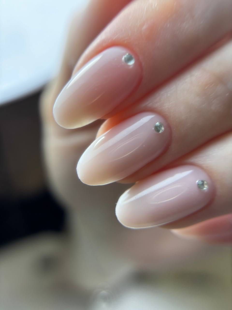 Natural nude nails with a single crystal at the cuticle