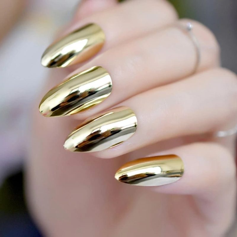 Gold chrome mirror nails with a reflective finish