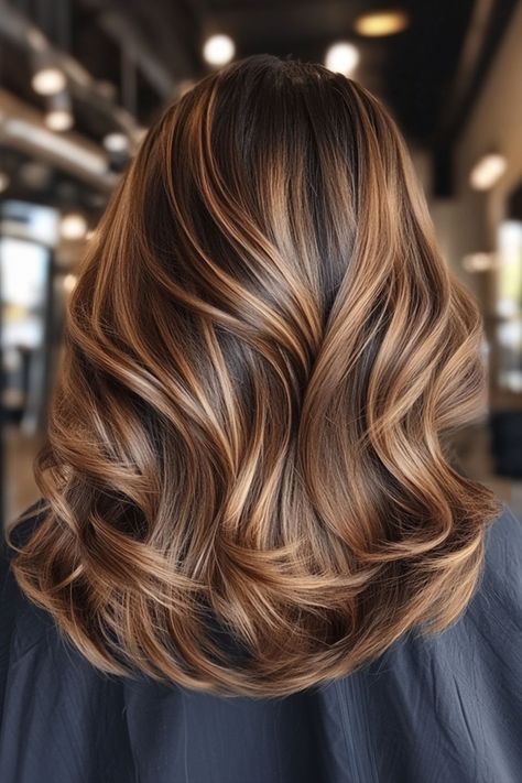 Dark brown hair with caramel face framing balayage