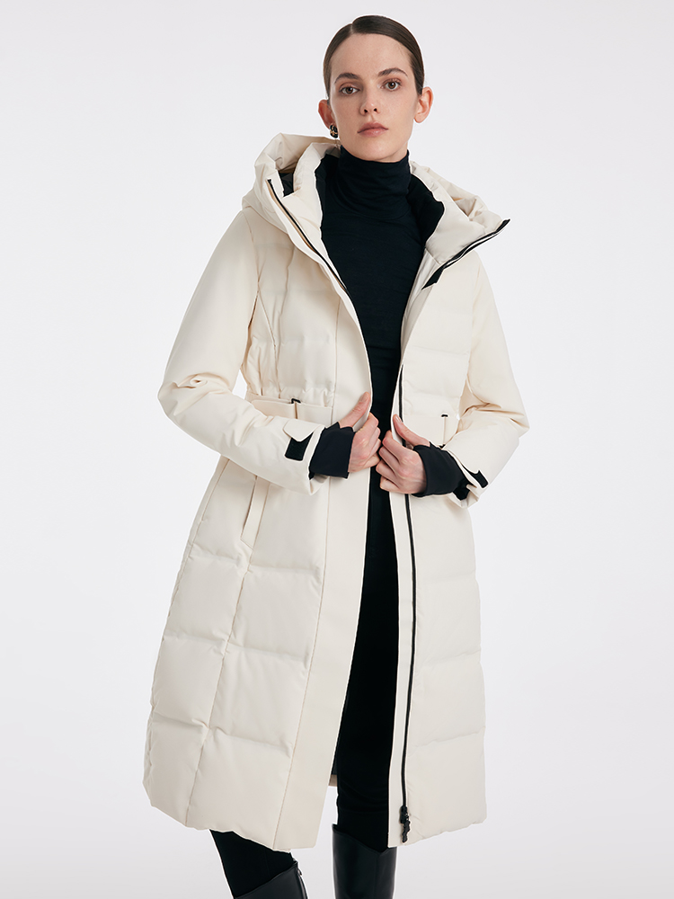 Woman in a long maxi puffer coat over a knit co-ord set