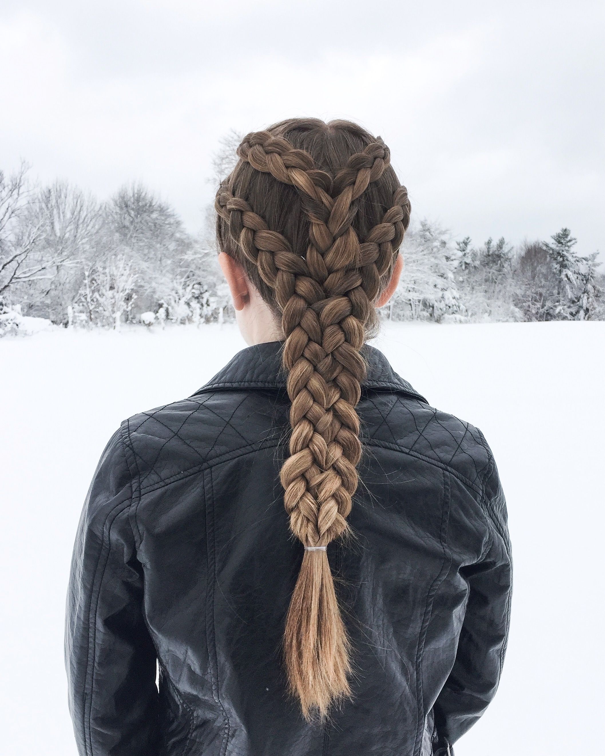 Twin dutch braids worn as pigtails with softly pancaked fullness