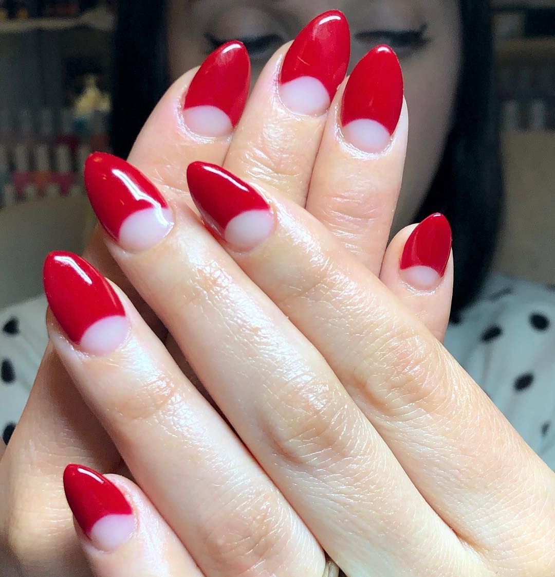 Red half moon manicure with bare cuticles