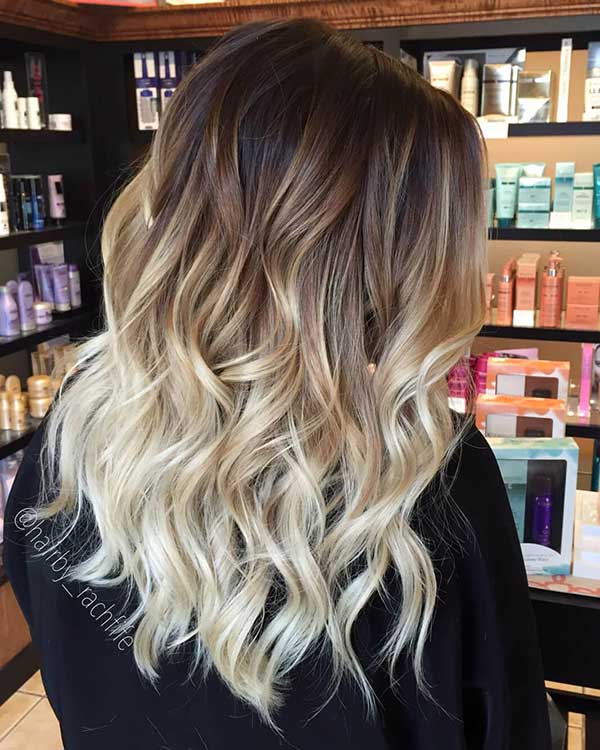 Dark root melt blending into caramel balayage hair