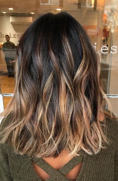 Brunette lob with warm toffee highlights
