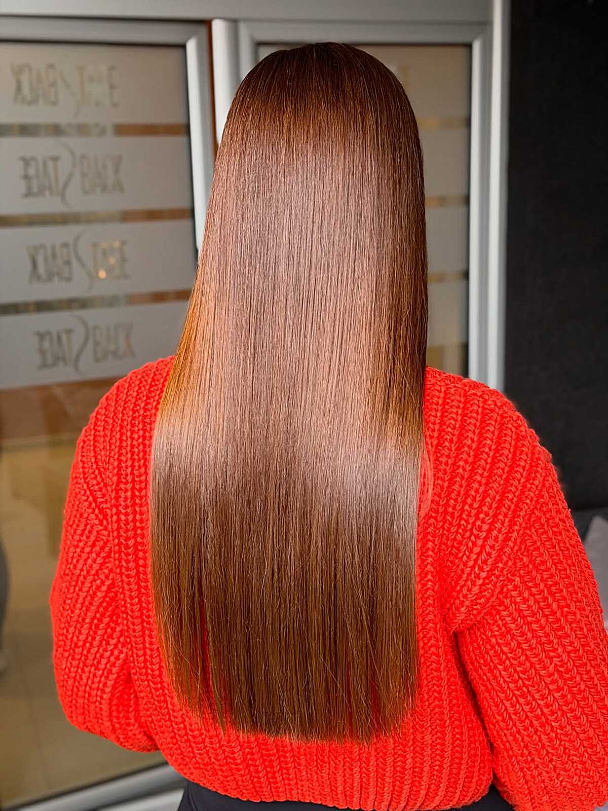 Long caramel brunette hair cut in a soft V shape with shine