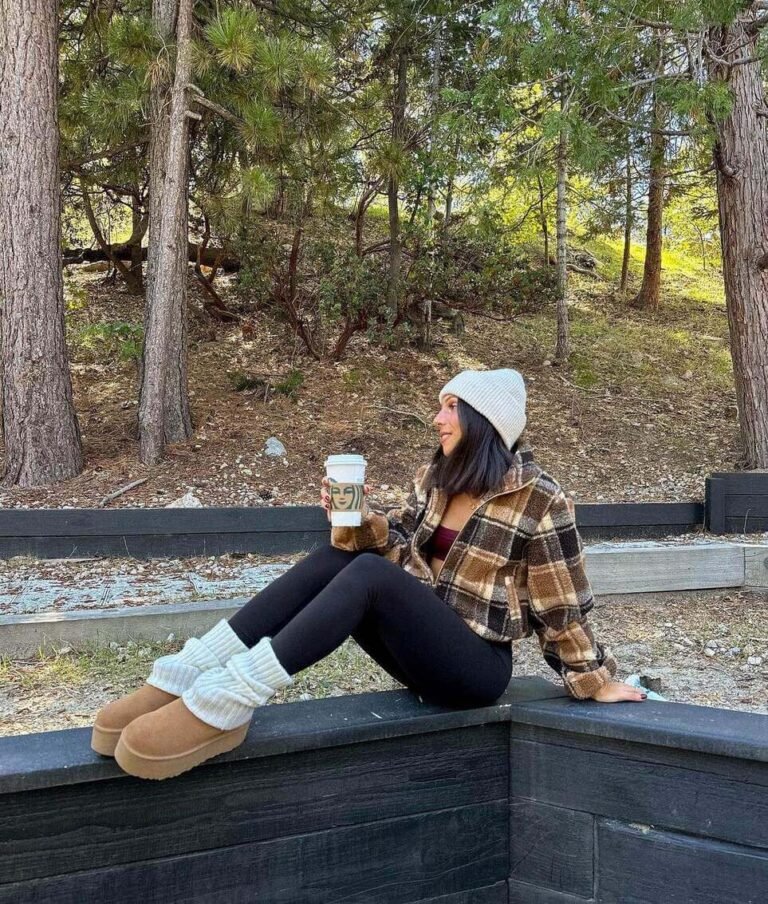 Woman in a plaid shacket and leggings wearing chestnut platform ugg boots with white socks