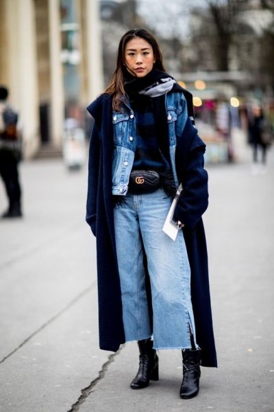 Woman in denim-on-denim under a long wool coat