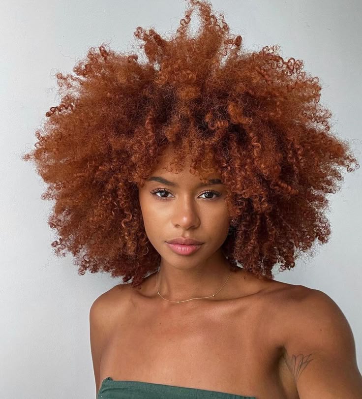 Ginger copper rounded afro on a Black woman