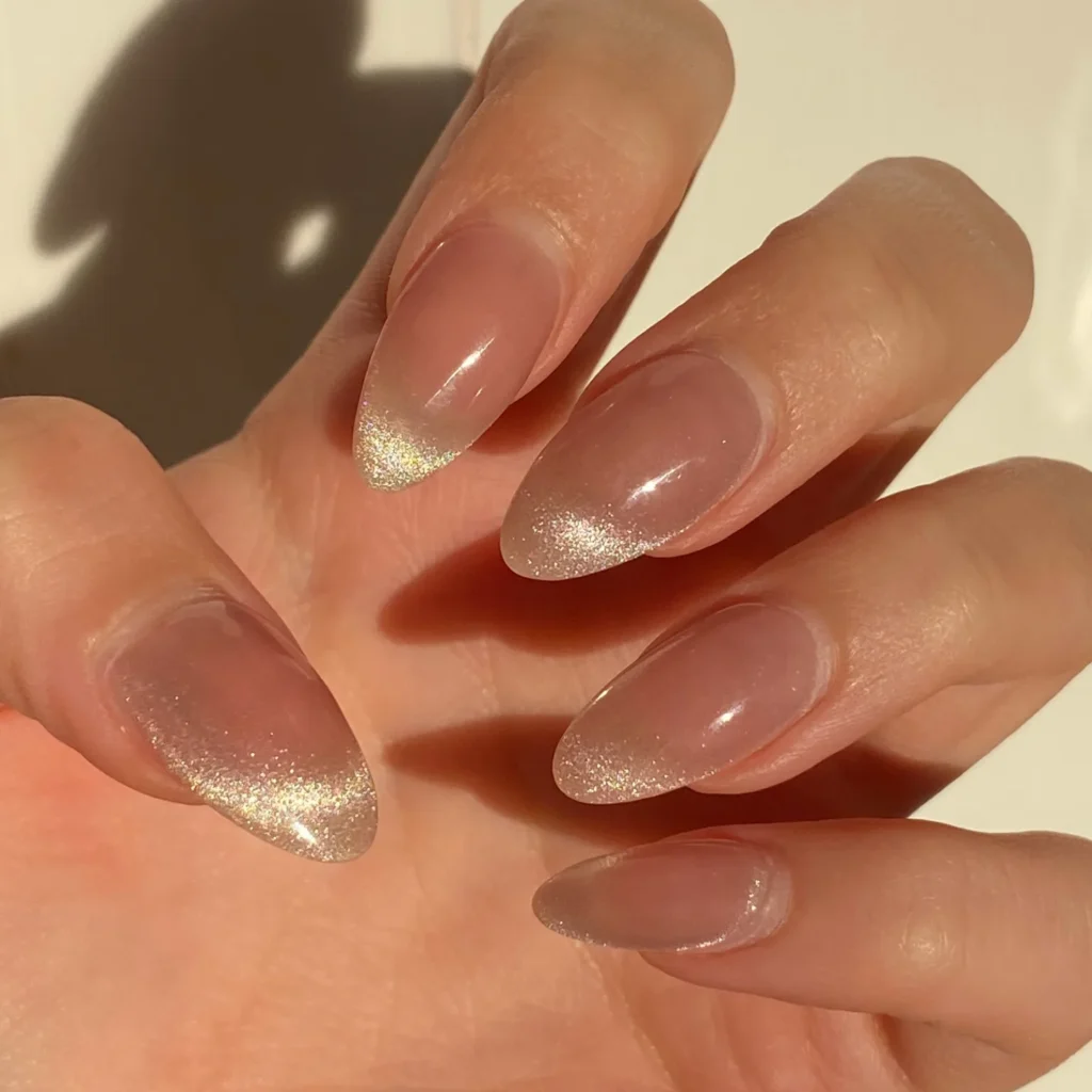 Gold-Dust Shimmer Over Nude: gold shimmer dusted toward the tips on almond nails