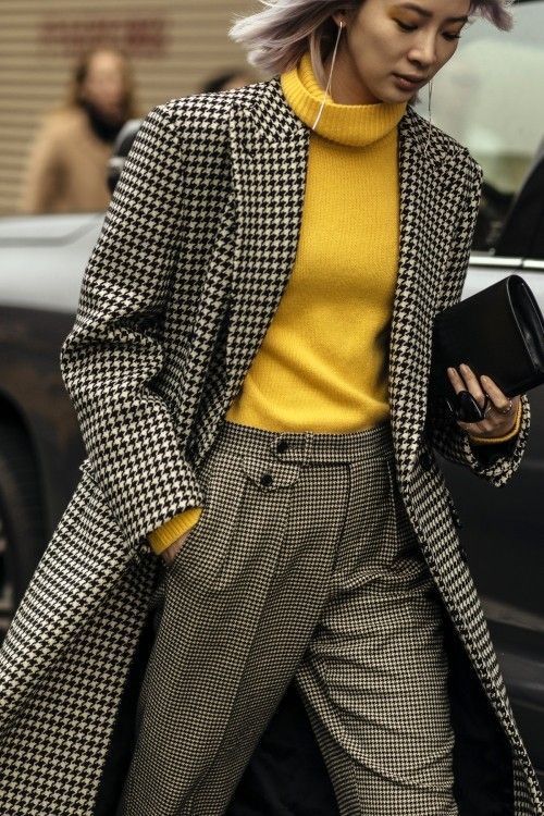 Woman in a houndstooth check coat in a street-style look