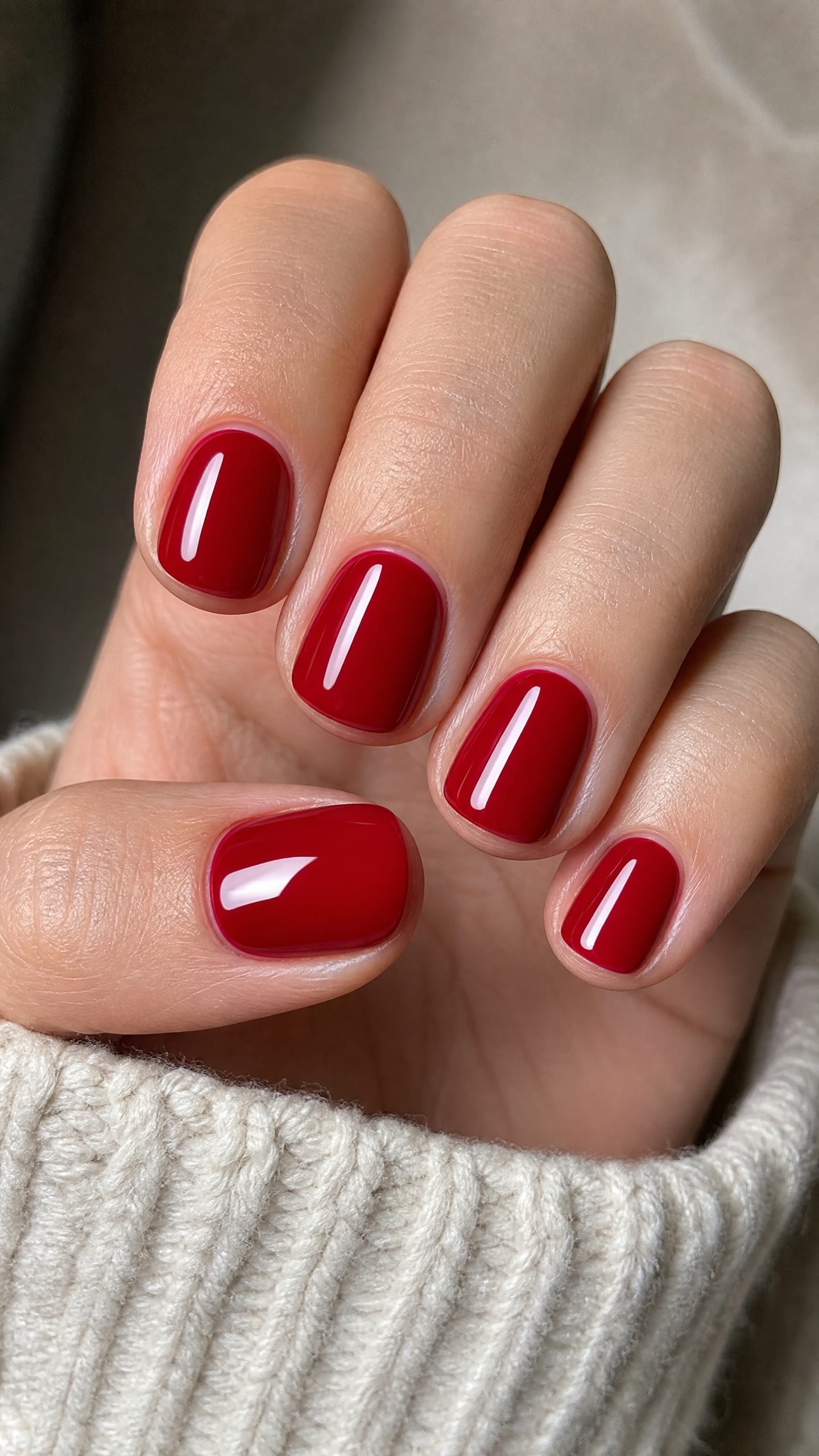Classic cherry red glossy polish on short oval nails