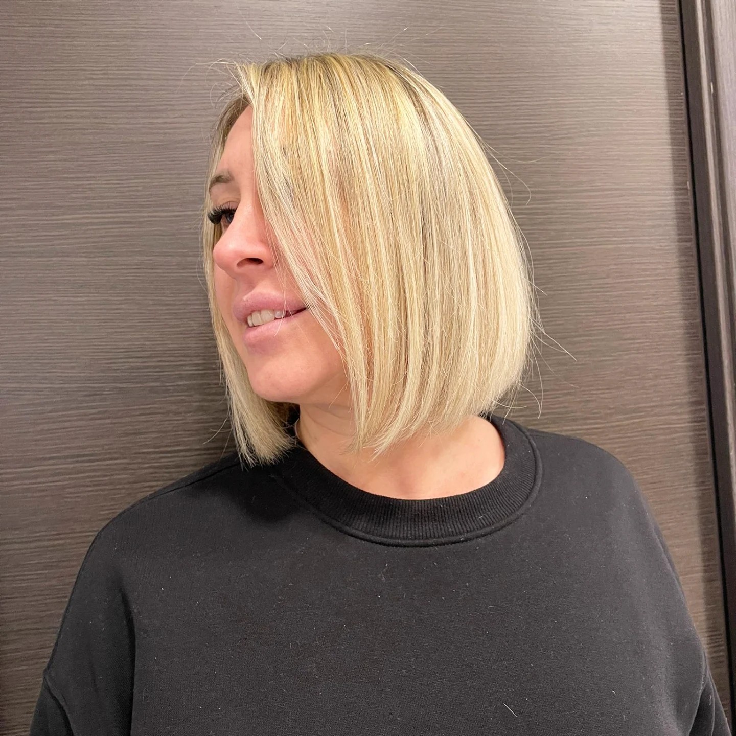 Blunt chin-length Italian bob with long diagonal face-framing slice