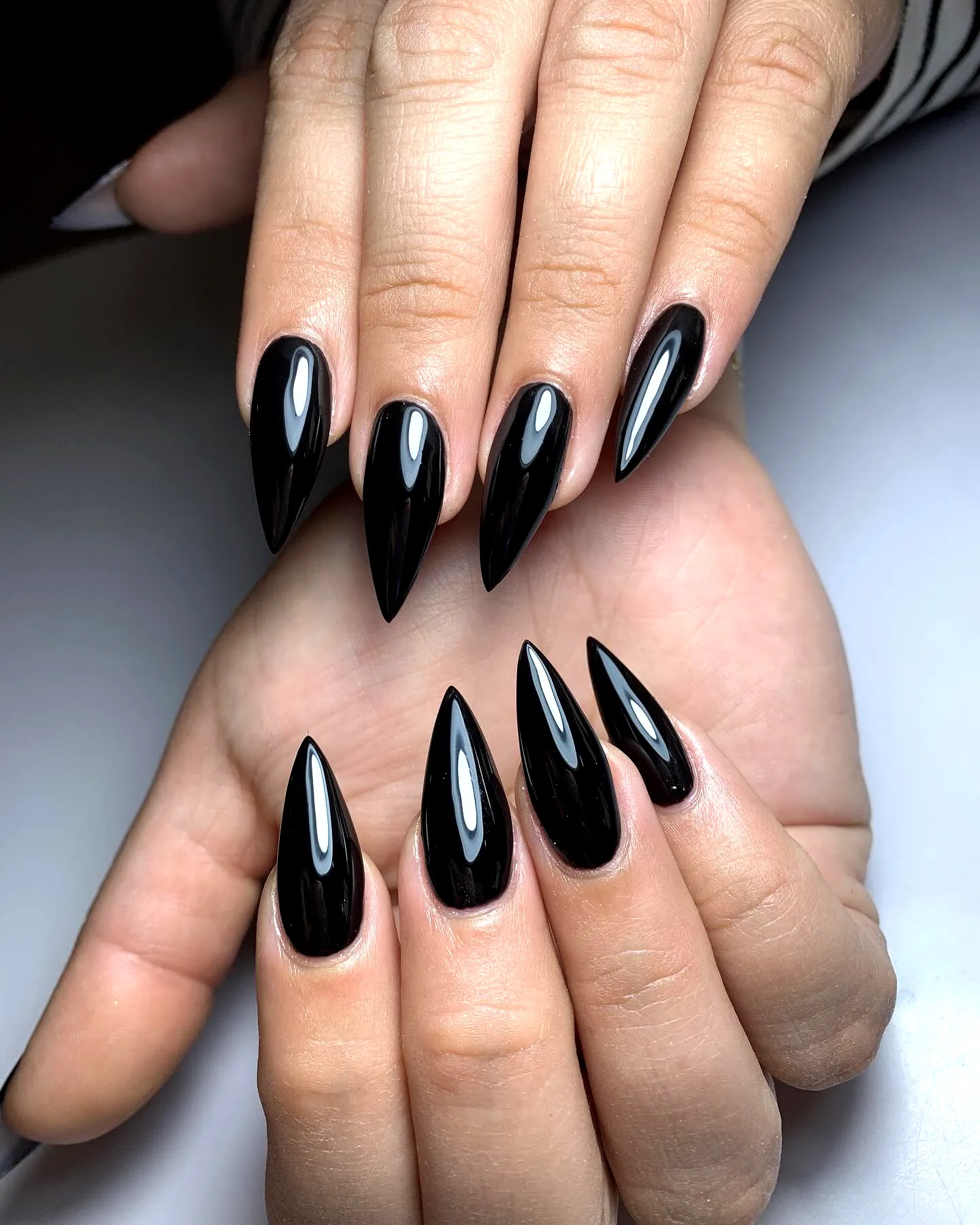 Glossy black stiletto nails