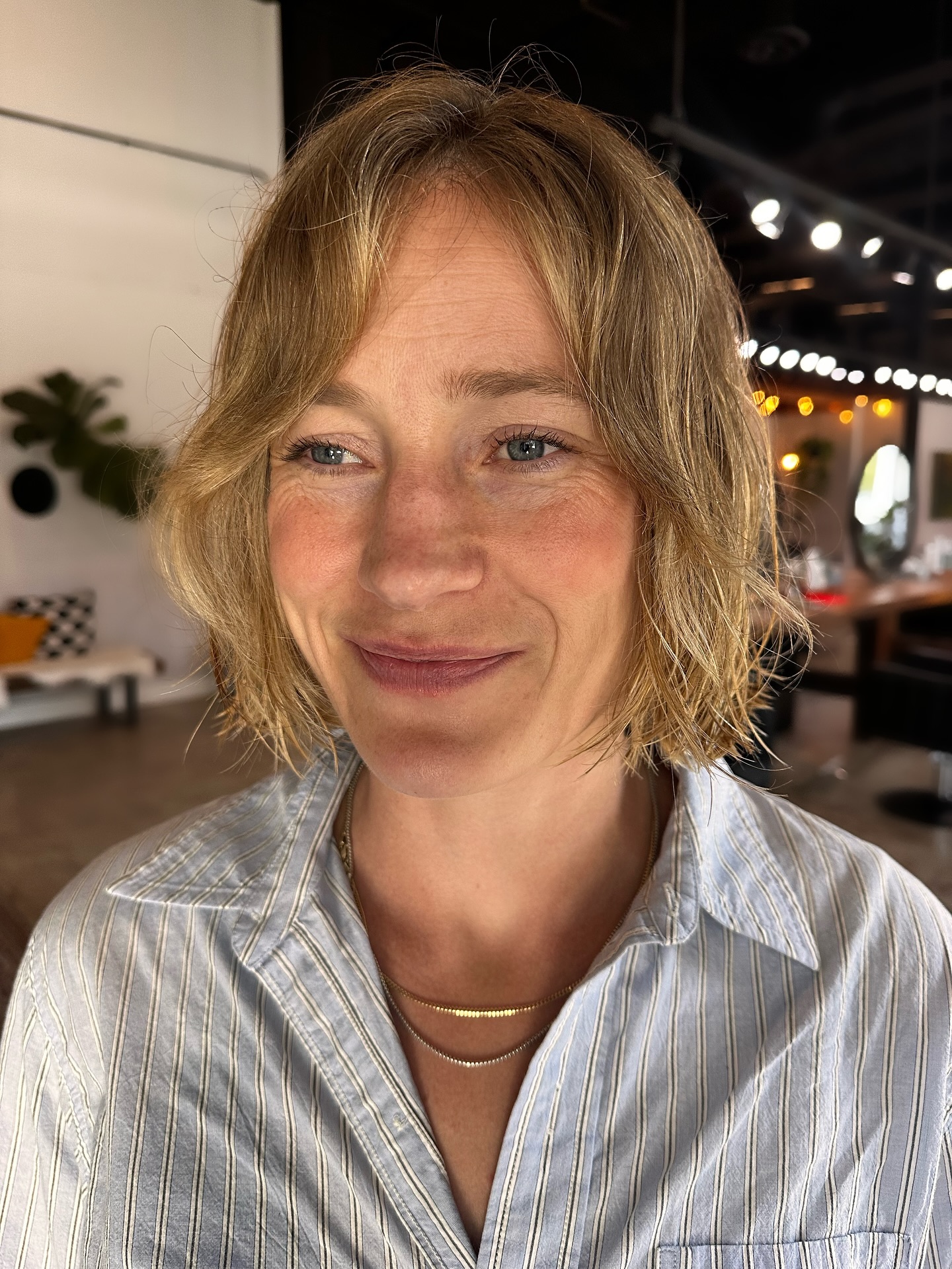 Textured chin-length Italian bob with wispy center-part fringe