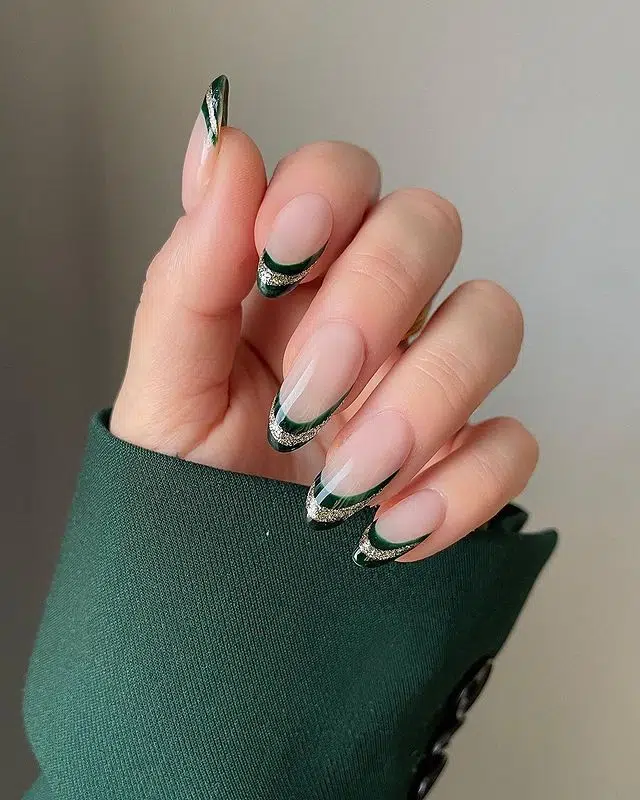 Emerald French tip nails with silver glitter accents