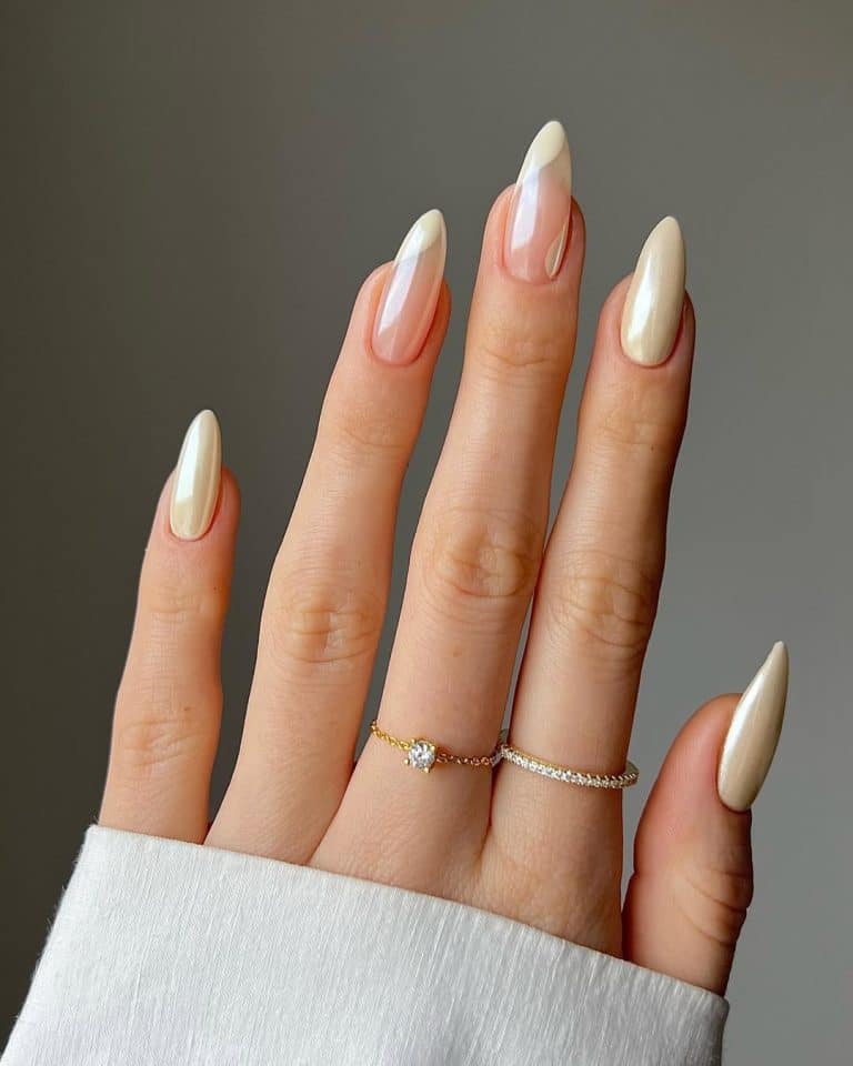 Long almond nails with pearl-white chrome fading into a soft nude gradient