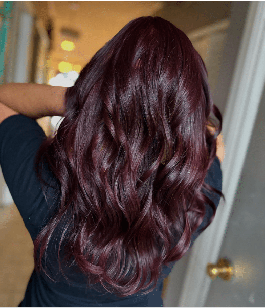 Back view of long wavy hair in classic all-over cherry cola color